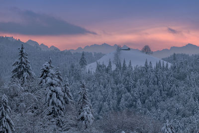 Scenic view of snow mountains against sky during sunset