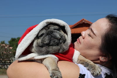 Close-up of woman carrying dog