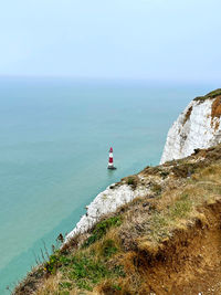Lone lighthouse off the chalky cliffs coast of beachy head