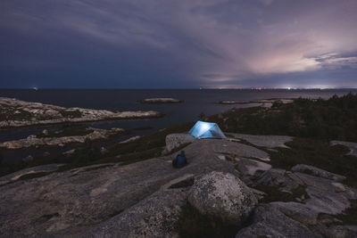 Couple talking nearby their tent while camping at pollys cove, nova scotia, canada