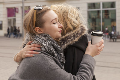 Close-up of young woman drinking coffee