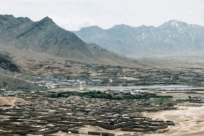 A village under the mountain in afghanistan. a typical small village cluster near kabul.