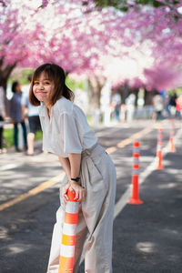 Portrait of woman standing on road