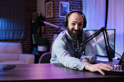 Portrait of young man using laptop on table