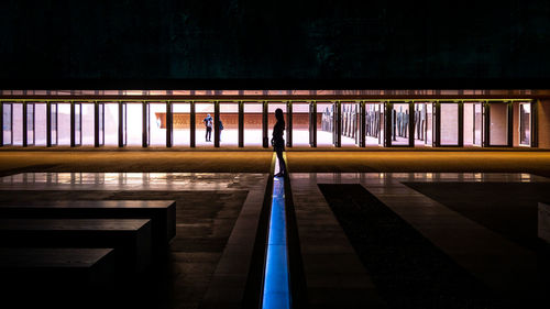 Person on illuminated staircase in building at night