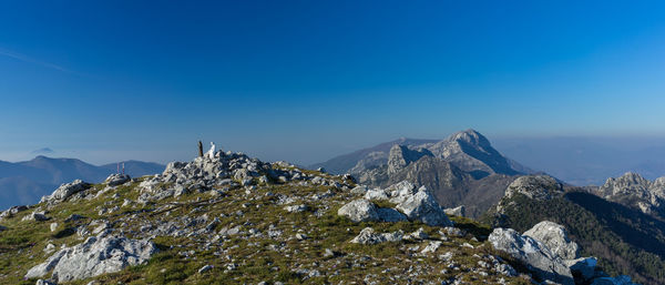 Scenic view of mountains against clear blue sky