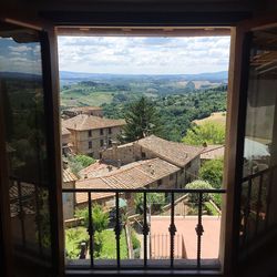 Trees and houses seen through window