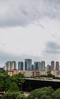 Buildings in city against sky