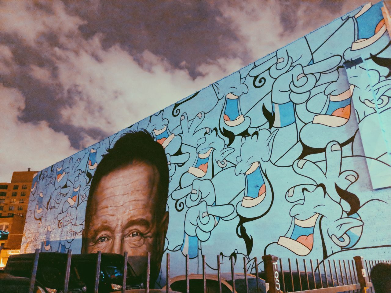 sky, cloud - sky, low angle view, architecture, graffiti, built structure, building exterior, nature, creativity, one person, day, real people, art and craft, portrait, outdoors, men, city, headshot, lifestyles, mural
