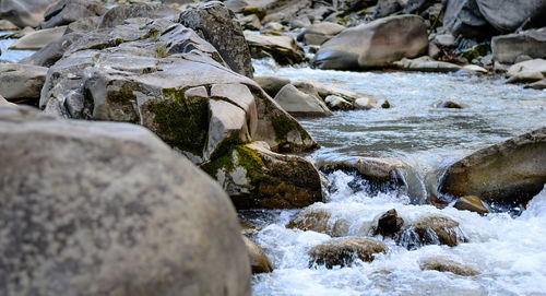 View of river flowing through rocks
