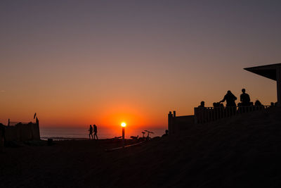 Silhouette people at beach