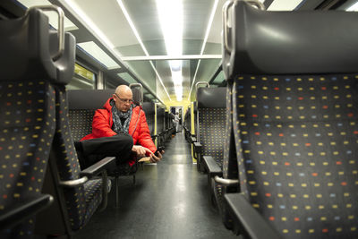 Man using phone while sitting in train