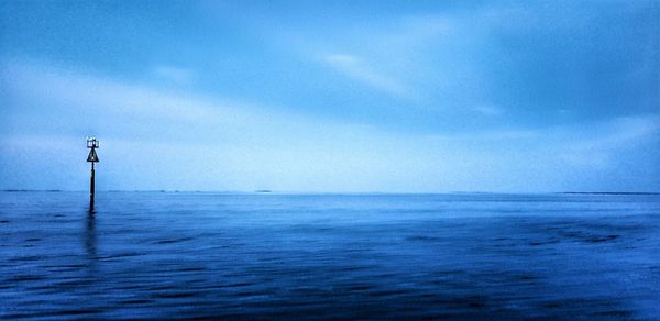 Scenic view of sea against blue sky
