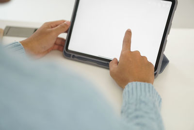 Midsection of man using mobile phone