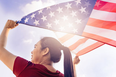 Low angle view of woman with american flag