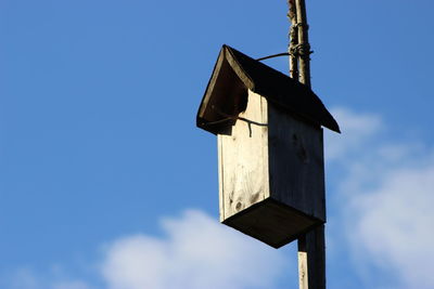 Close-up of birdhouse against sky