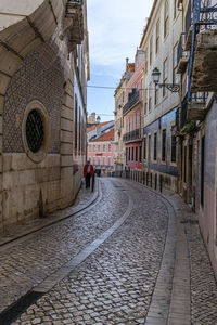 Street amidst buildings against sky