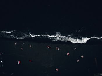 Aerial view of people at beach during night