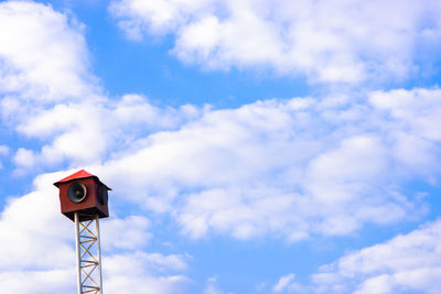 Low angle view of megaphone against blue sky