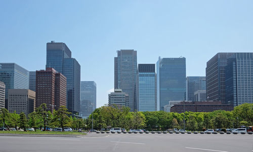 Skyscrapers in city against blue sky