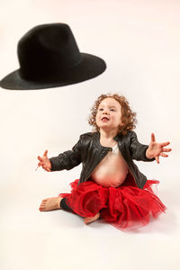 Full length of young woman standing on white background