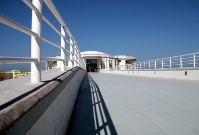 Empty walkway leading towards building
