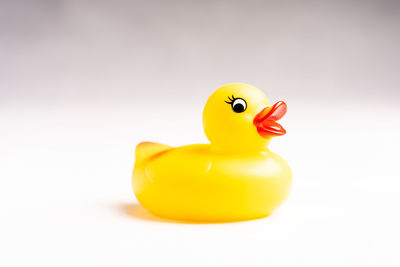 Close-up of yellow toy over white background