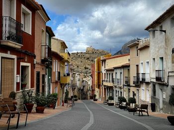 Street amidst buildings against sky