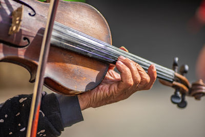 Cropped hands of person playing violin