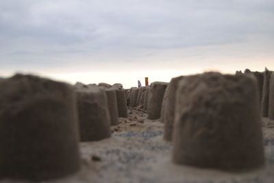 Panoramic shot of rocks on beach against sky