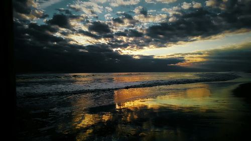 Scenic view of sea against cloudy sky