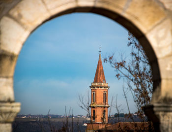 Low angle view of bell tower against sky