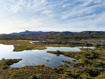 Beautiful scenery of winding river against highland in sunny day