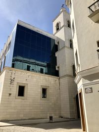 Low angle view of building against cloudy sky