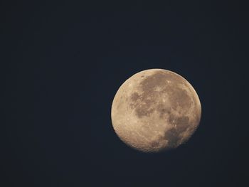 Low angle view of moon against clear sky at night