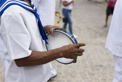 Men, members of the cultural group chegança dos marujos, dance and sing in costumes 