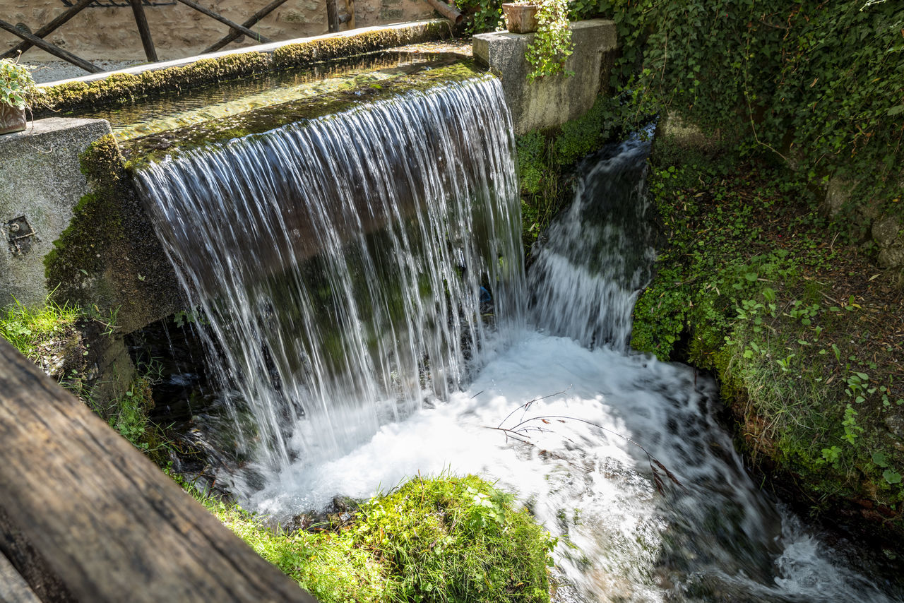 waterfall, water, motion, beauty in nature, scenics - nature, flowing water, nature, long exposure, watercourse, plant, body of water, environment, blurred motion, tree, flowing, splashing, no people, environmental conservation, water feature, forest, outdoors, day, river, rock, water resources, land, stream, sports, speed, power in nature, non-urban scene