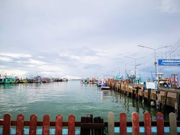 Boats moored in sea against sky