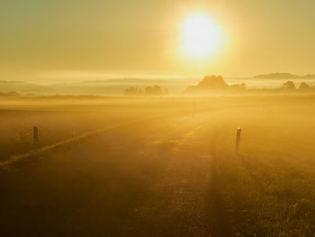 Scenic view of field against sky during sunset