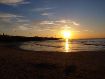 View of calm beach at sunset