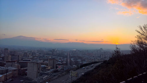 High angle view of buildings against sky during sunset