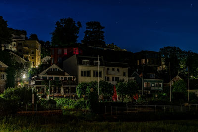 Low angle view of buildings against sky at night