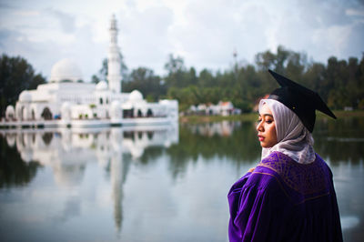 Portrait of man standing against water