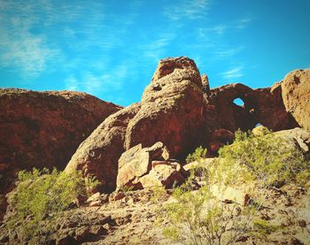 Low angle view of rock formation against sky