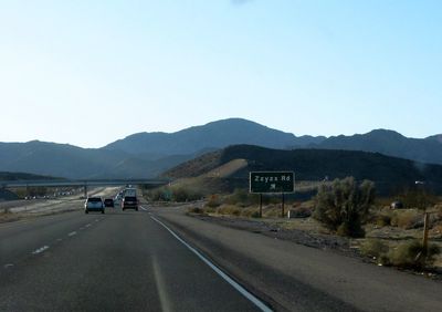 Road by mountain against clear sky