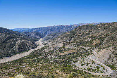 High angle view of mountains against clear blue sky