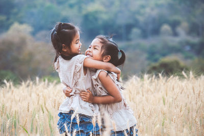 Happy mother and daughter on field