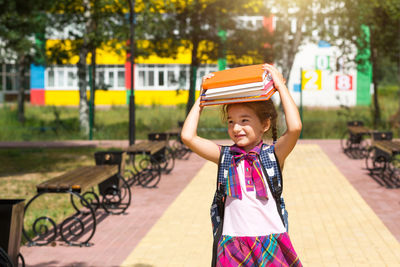 Portrait of a smiling girl standing outdoors