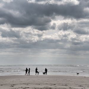 People on beach against sky