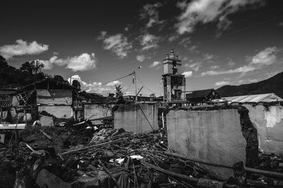 Crane by building against sky